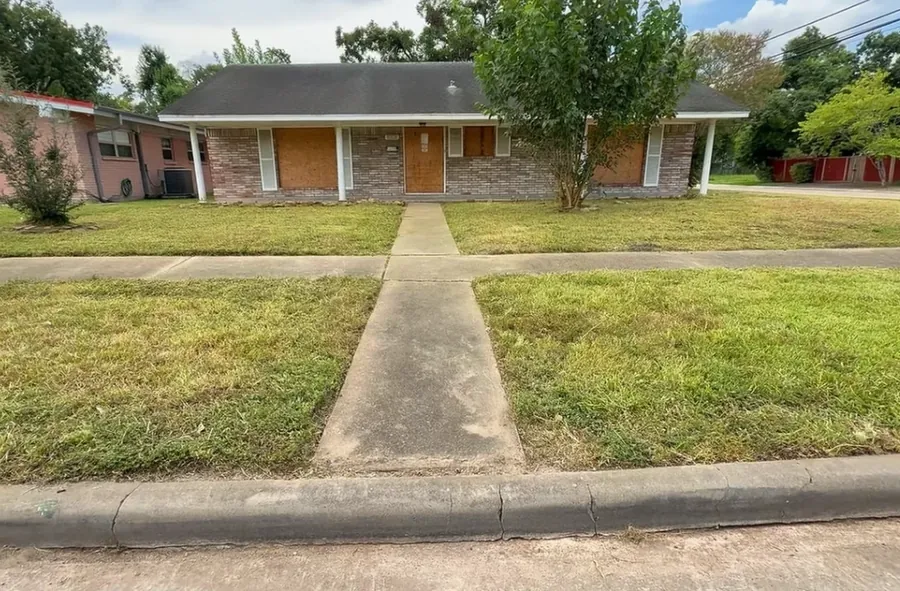Same yard after mowing, with a clear walkway and tidy curb appeal