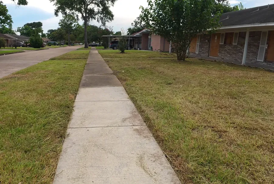 Manicured front yard with clean beds and even mowing stripes