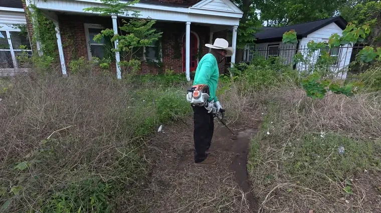 aiken landscaping crew clearing heavy brush and overgrown shrubs during yard restoration project