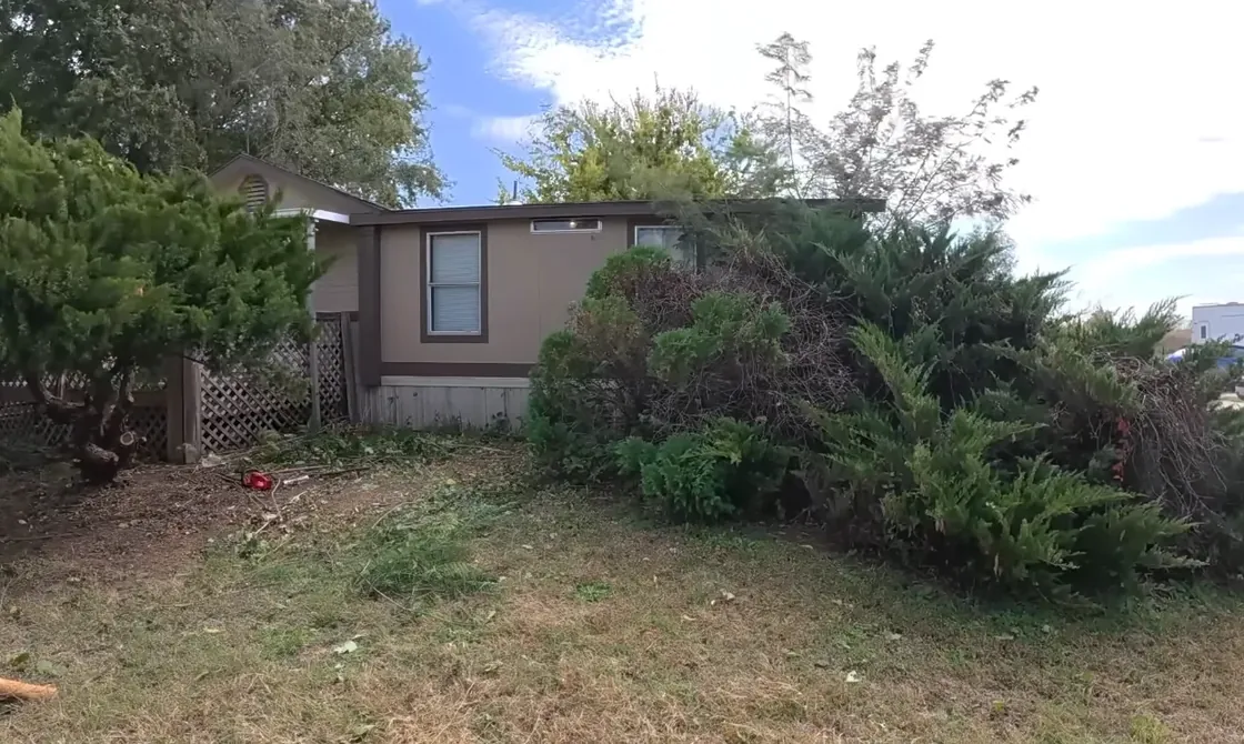 Crew applying fertilizer treatment to a Centipede grass lawn